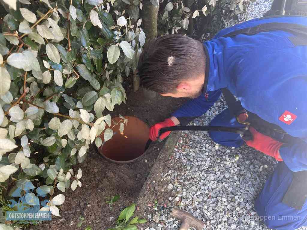 Monteur reinigt een rioolput met een slang, periodieke rioolreiniging in Emmen